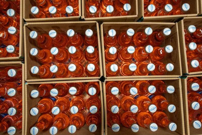 Top-down photo of cased glass bottles filled with product