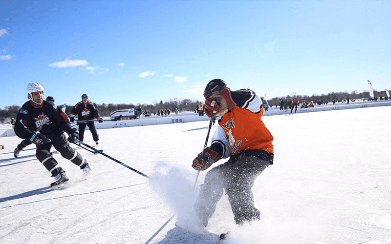 Photo of people playing ice hockey outdoors