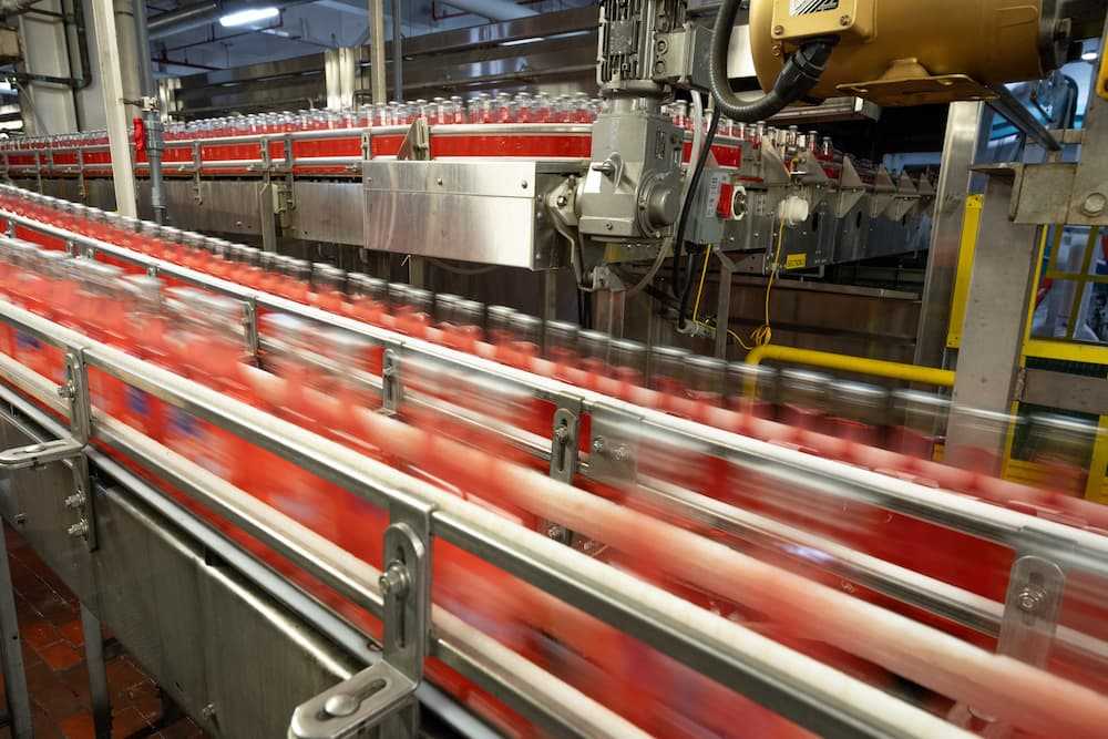 Photo of fast-moving bottles on a packaging line